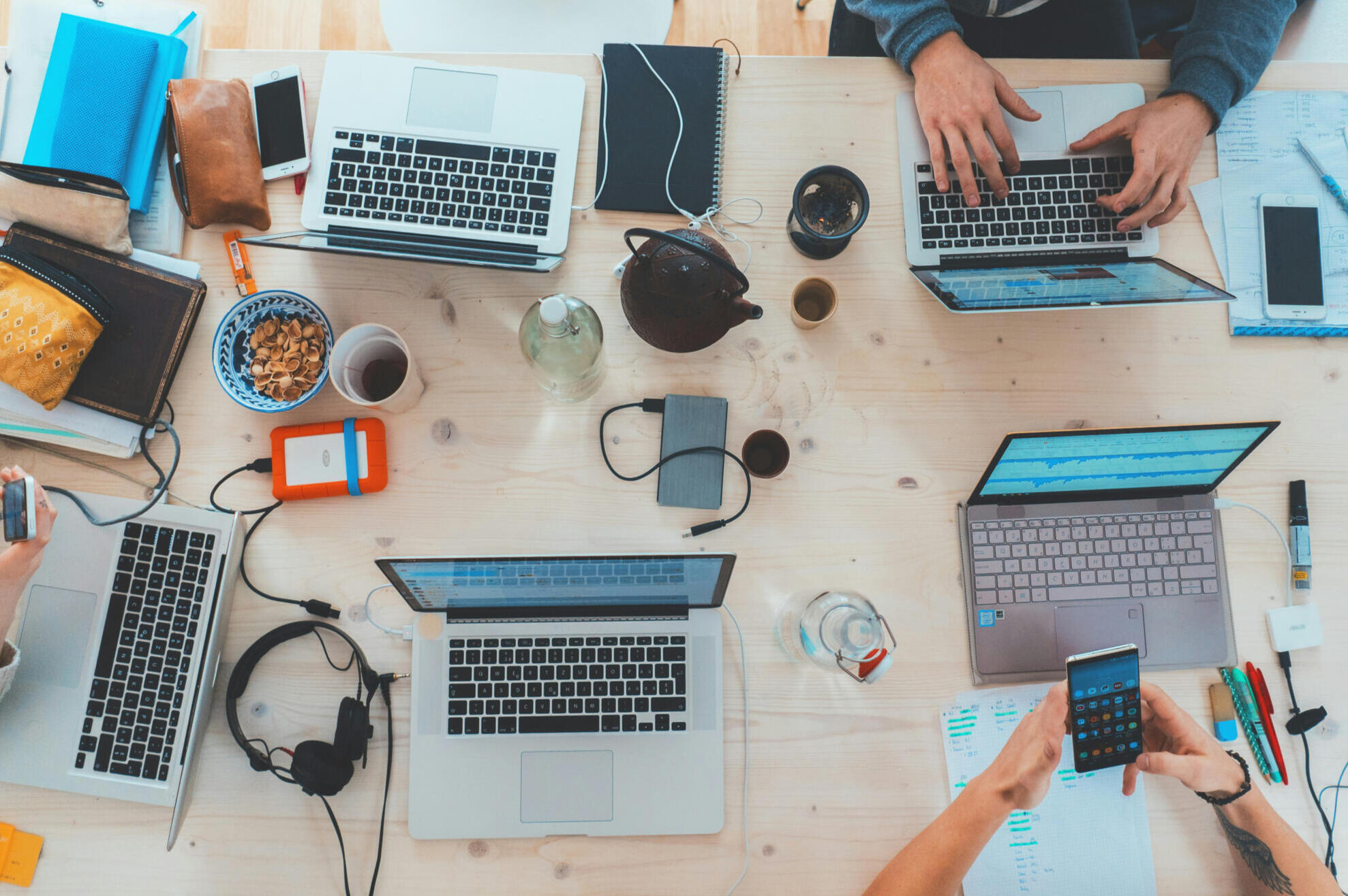 People working on computers around a table